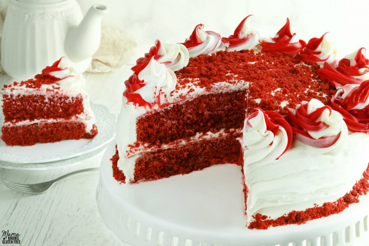 gluten-free red velvet cake cut with a slice of cake in the backgorund