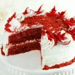 gluten-free red velvet cake with slice cut out of it