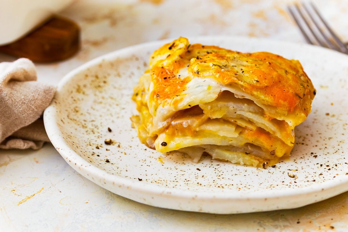 Side view of gluten-free scalloped potatoes on a plate.