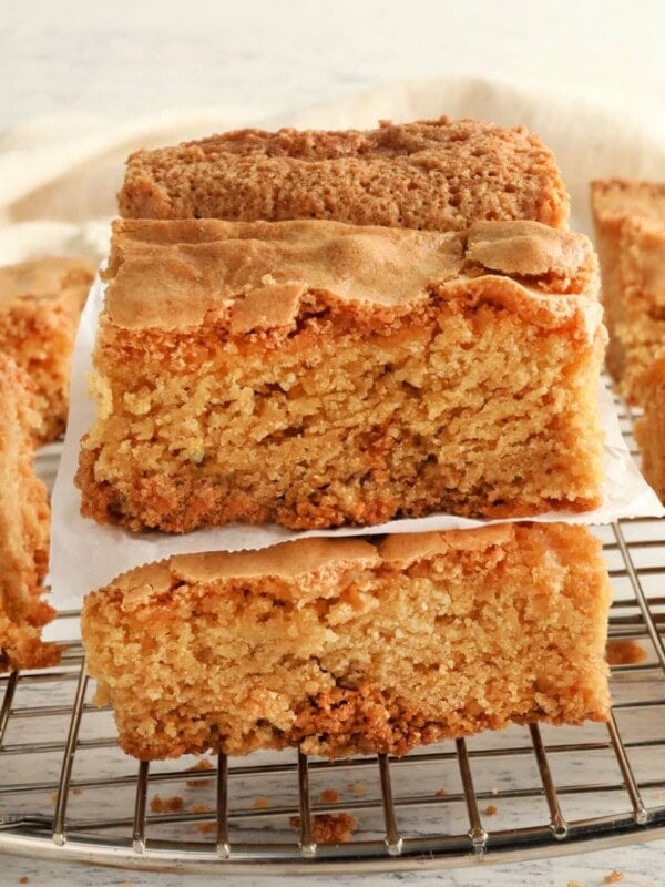 gluten-free blondies stacked on top of each other on a cooling rack