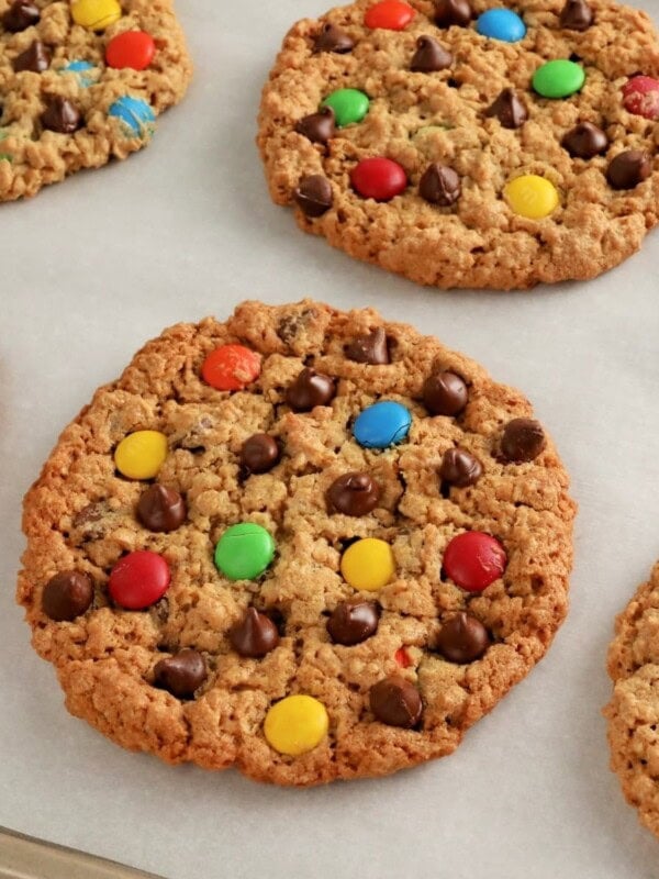 gluten-free monster cookies on white parchment paper.