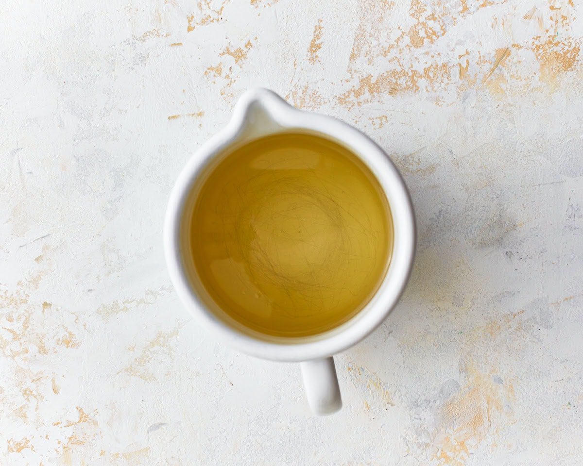 yeast, water, and sugar in a bowl.
