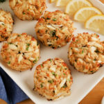 gluten-free crab cakes cakes on a white platter with lemon slices