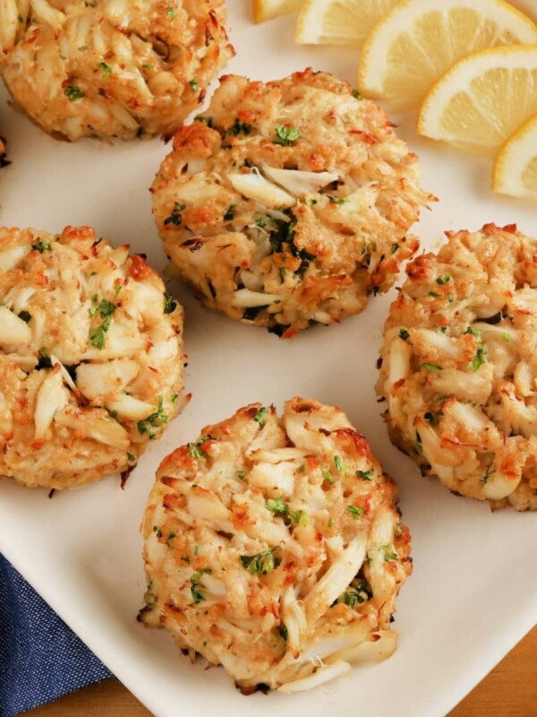 gluten-free crab cakes cakes on a white platter with lemon slices