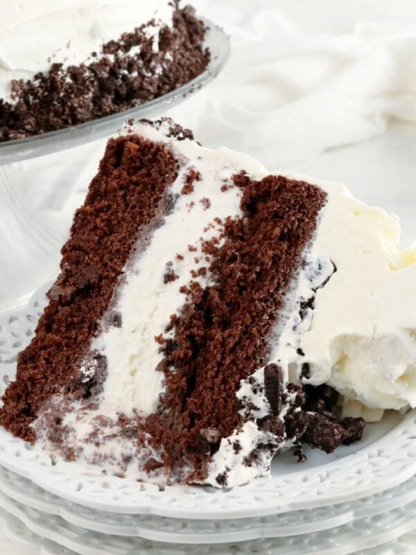 gluten-free ice cream cake slice on a white plate with the cake in the background