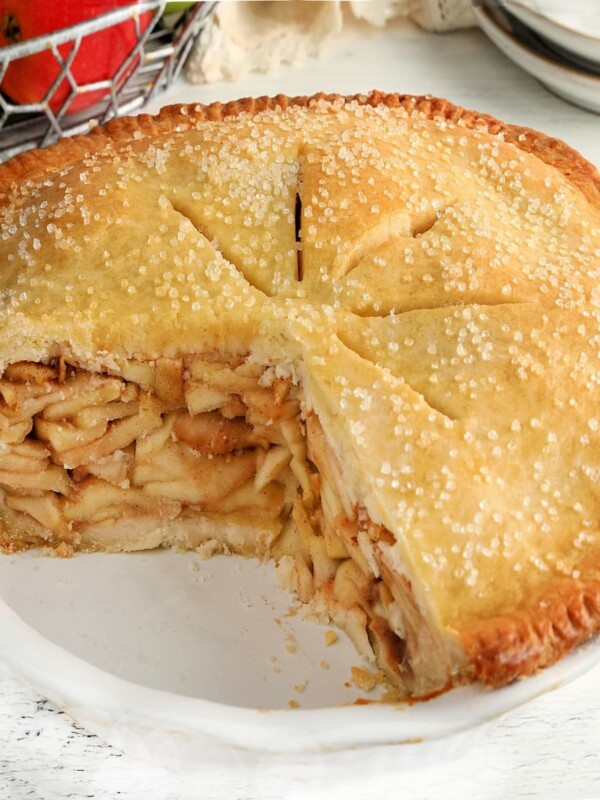 gluten-free apple pie with apples in the background