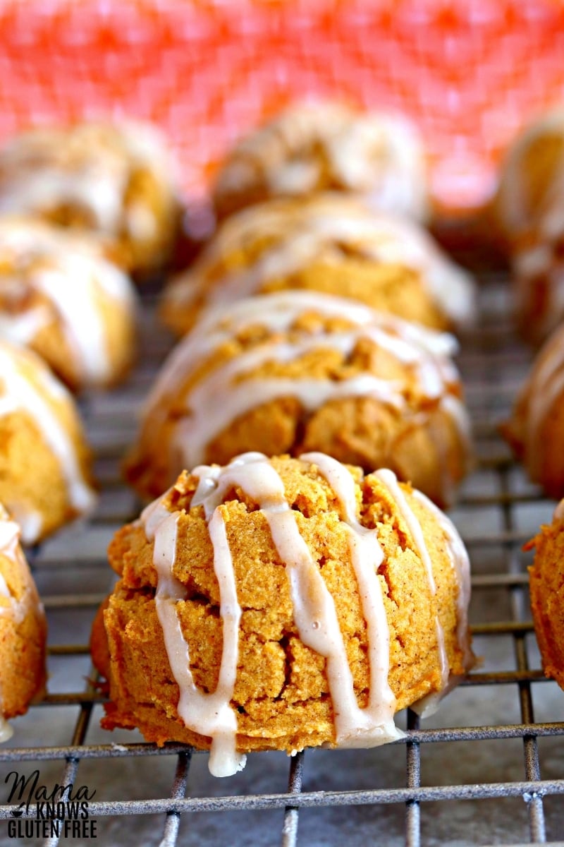 gluten-free pumpkin cookies with icing on a cooling rack