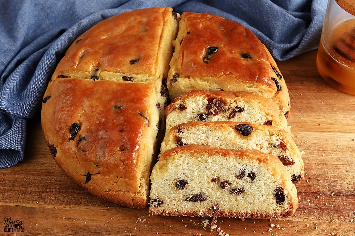 gluten-free Irish soda bread sliced on a cutting board with a blue kitchen towel