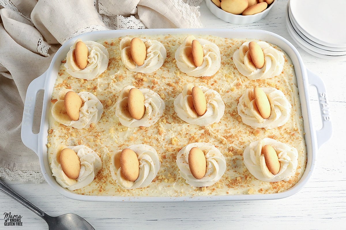 gluten-free banana pudding in a white baking dish with vanilla wafers in the background