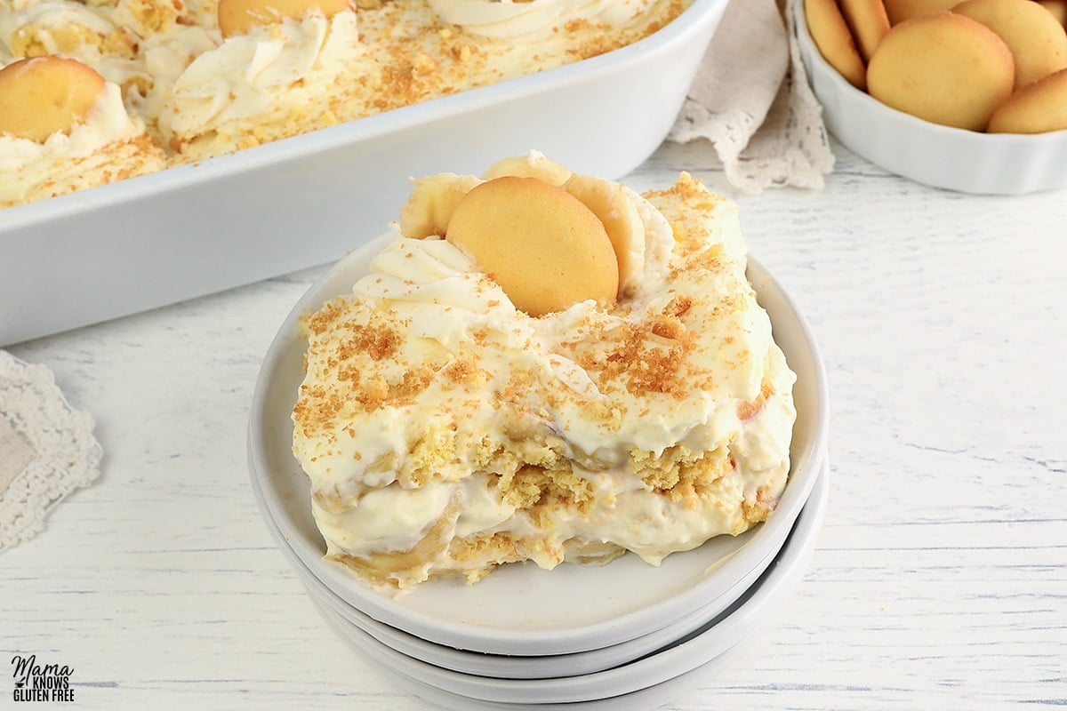 gluten-free banana pudding serving on a white plate with the pudding in white dish in the background