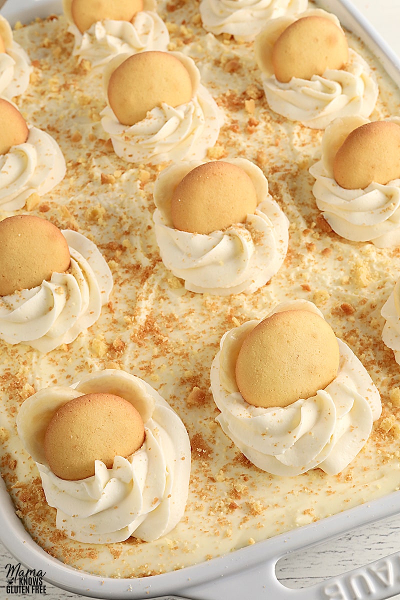 gluten-free banana pudding topped with whipped cream, wafers, and sliced bananas
