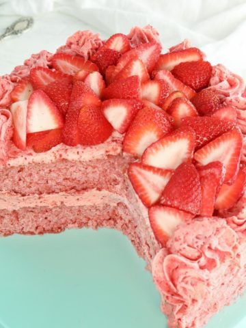 gluten-free strawberry cake on a blue cake plate