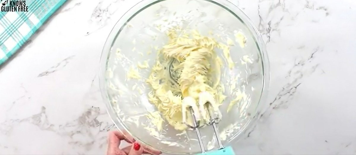 Creaming butter with an electric hand mixer.