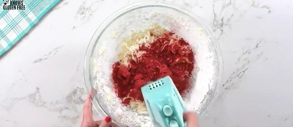 Blending the strawberry powder into the sugar and other ingredients.