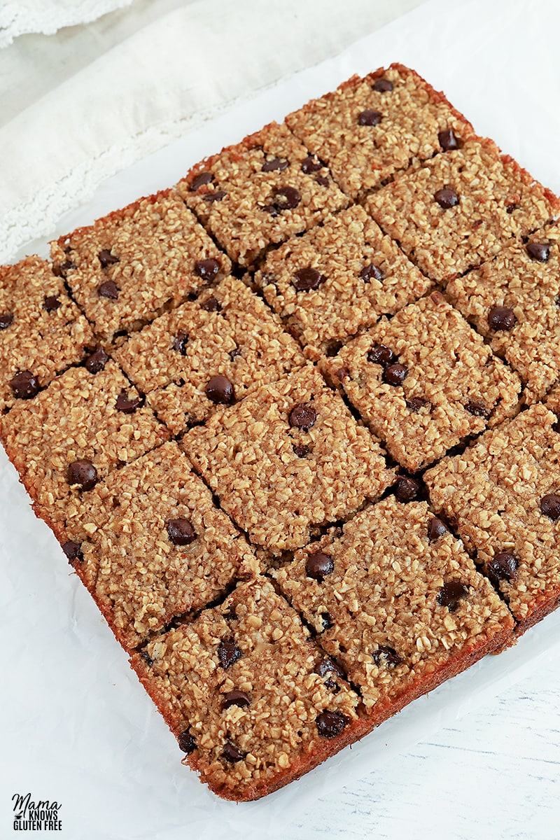 oatmeal bars cut into squares on white parchment paper
