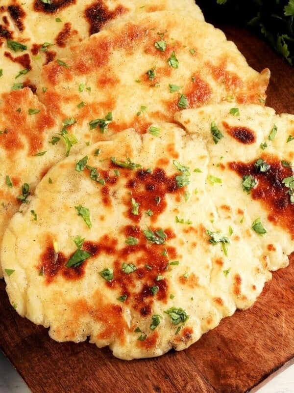 gluten-free naan bread on a brown wooden cutting board