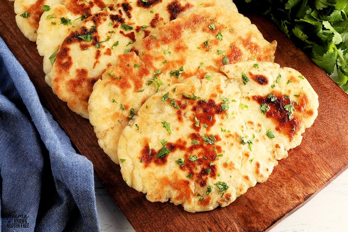 gluten-free naan bred on a brown cutting board