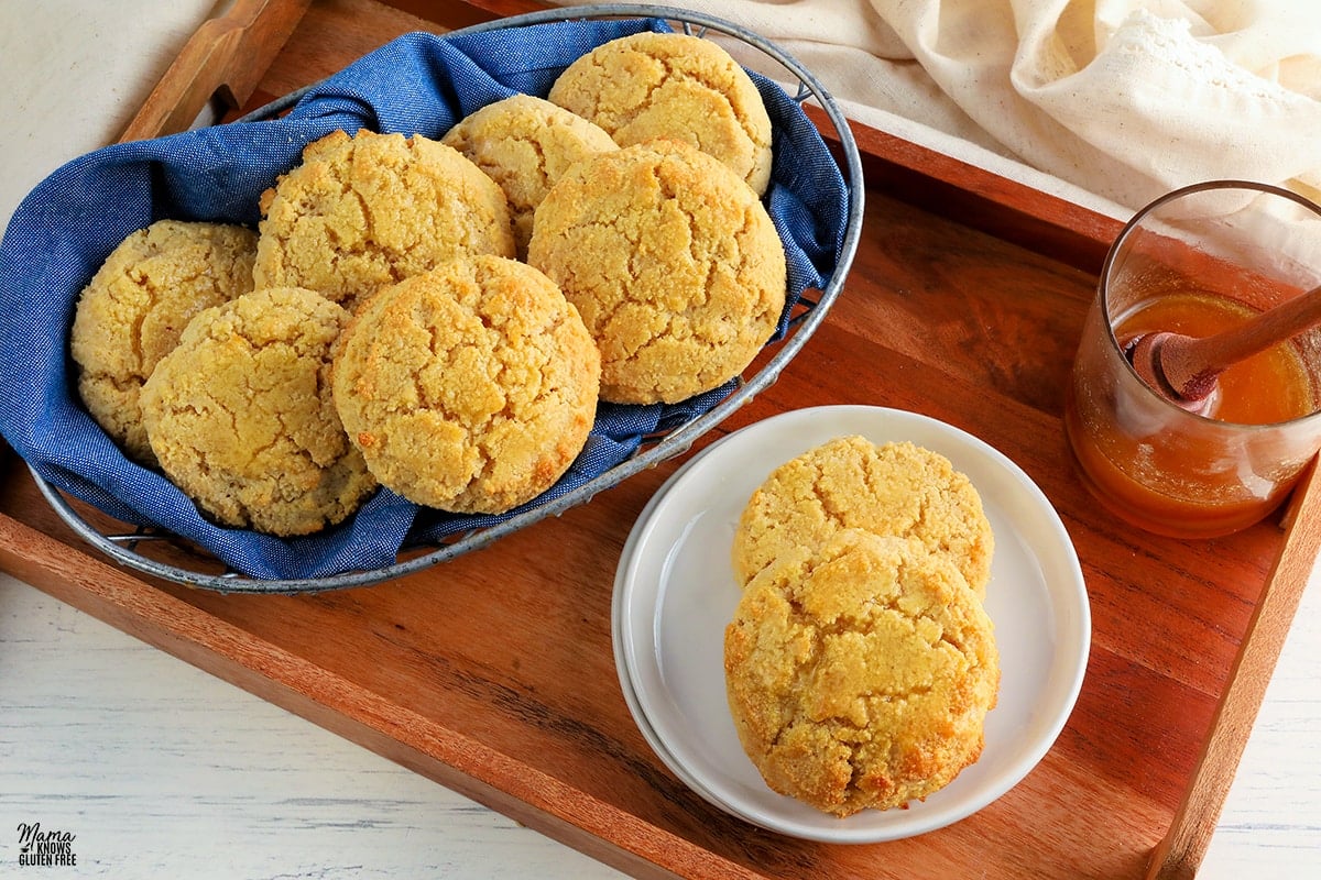 almond flour biscuits on a white plate and in a basket on a wood tray