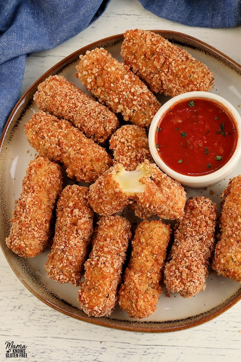 glutrn-free mozzarella stick on a white plate and marinara sauce 