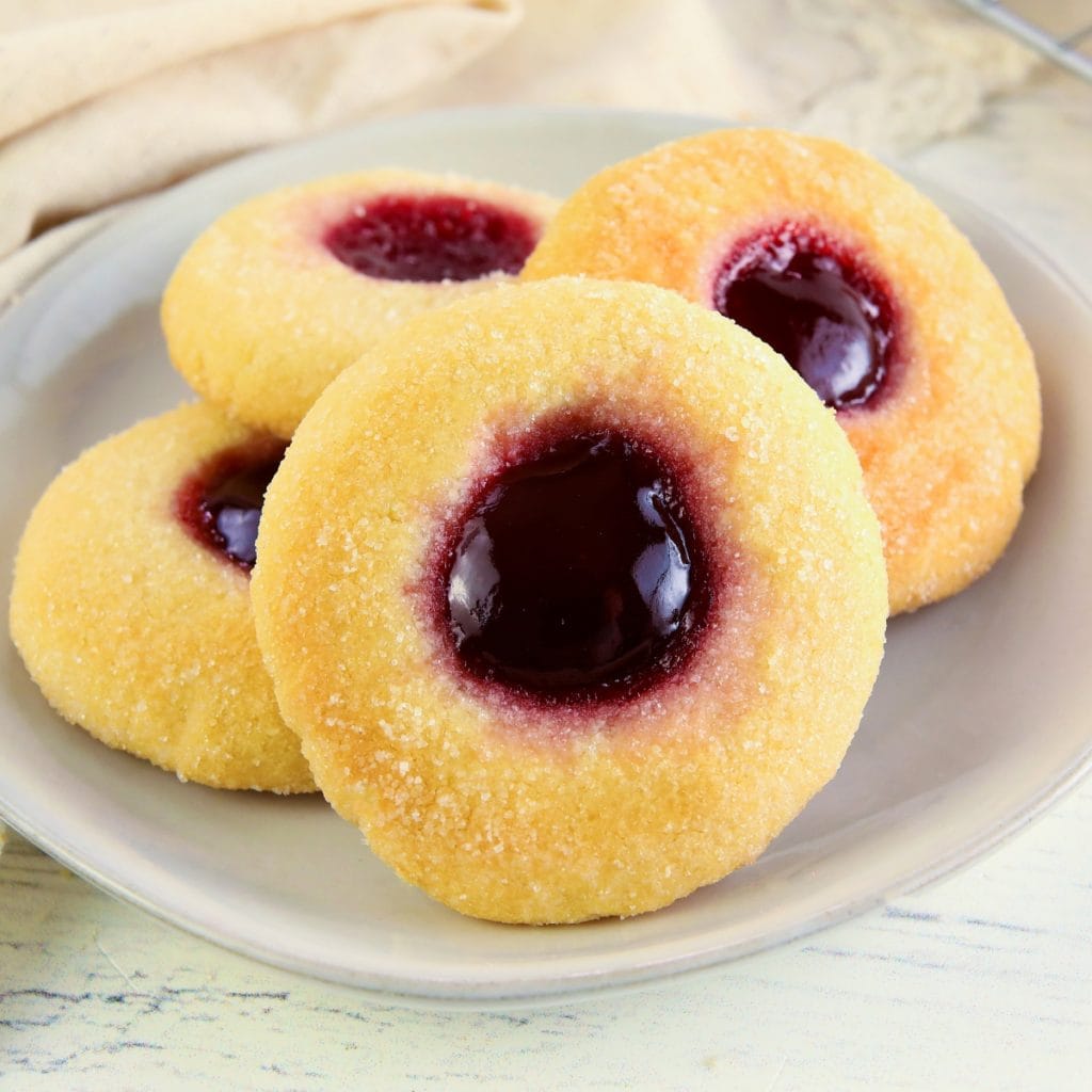 gluten-free thumbprint cookies on a white plate