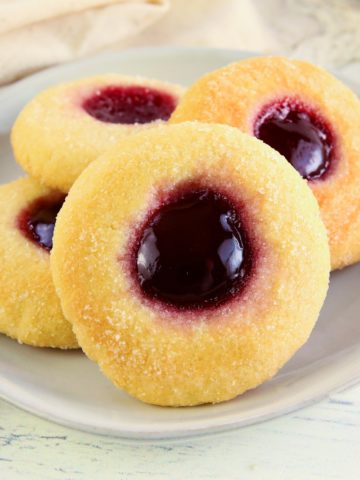 gluten-free thumbprint cookies on a white plate