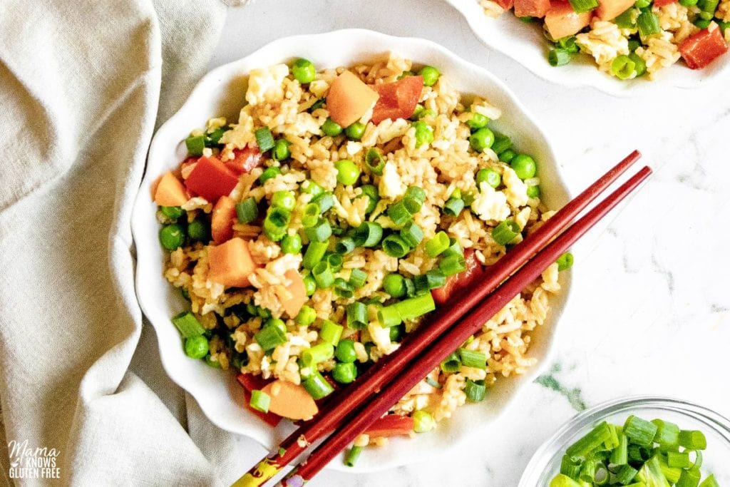 Gluten-Free Fried Rice in a bowl with chop sticks across.