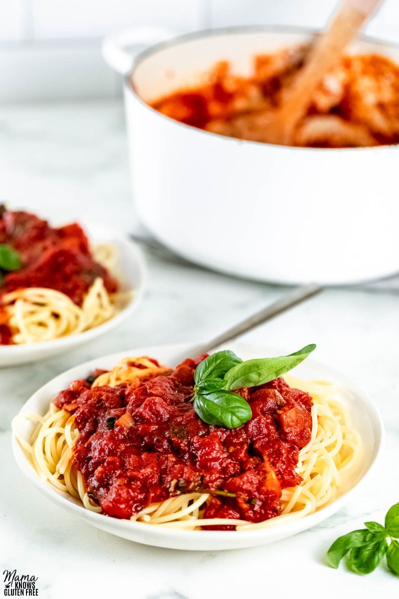 gluten-free spaghetti sauce over pasta and the post of sauce in the background