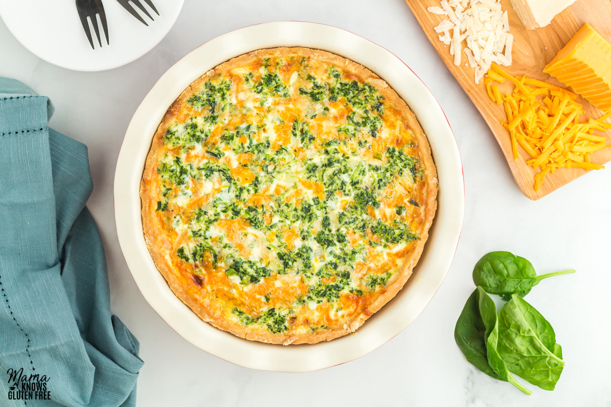 Gluten-free spinach quiche with some basil and cheese on the side.