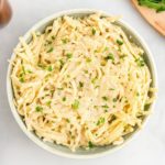 gluten-free Alfredo sauce and pasta in a bowl topped with parsley