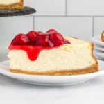 gluten-free cheesecake slice topped with cherry pie filling