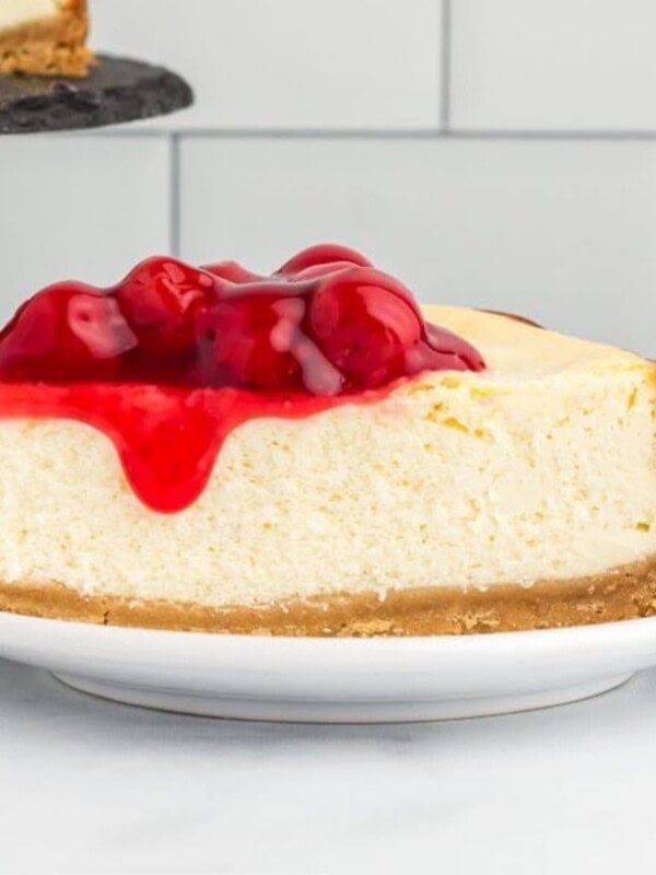 gluten-free cheesecake slice topped with cherry pie filling