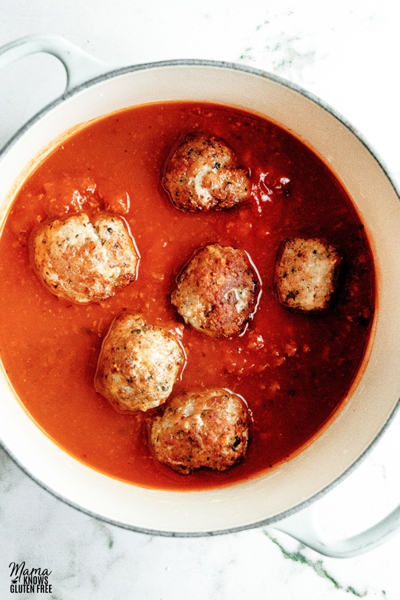 gluten-free turkey meatballs in a pot of tomato sauce