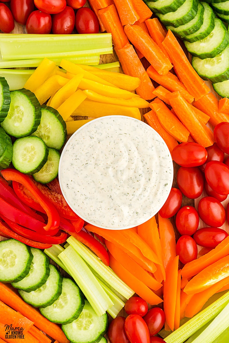 dairy-free ranch dressing in a white bowl surrounded by vegetables
