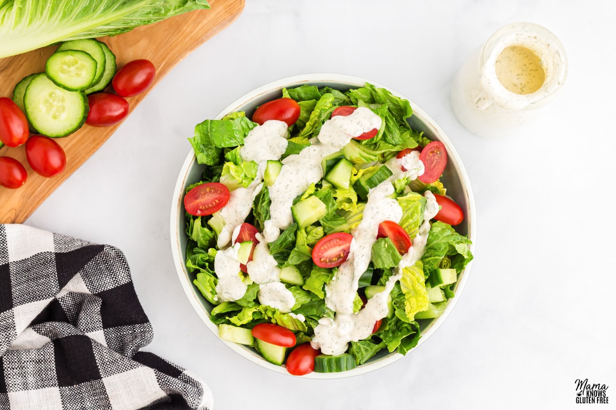 dairy-free ranch dressing poured over a salad in a white bowl