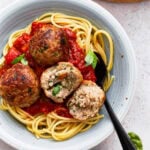 Gluten free turkey meatballs on a plate with spaghetti and marinara sauce