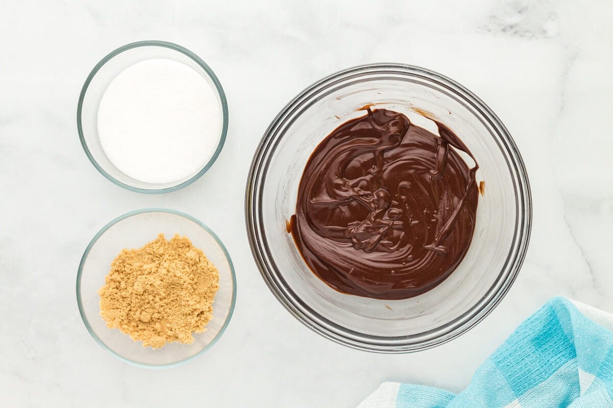 Melted chocolate in a glass mixing bowl.