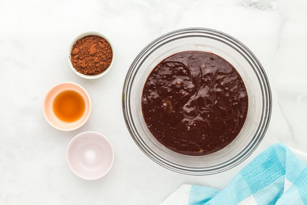 Flourless brownie batter in a glass mixing bowl.