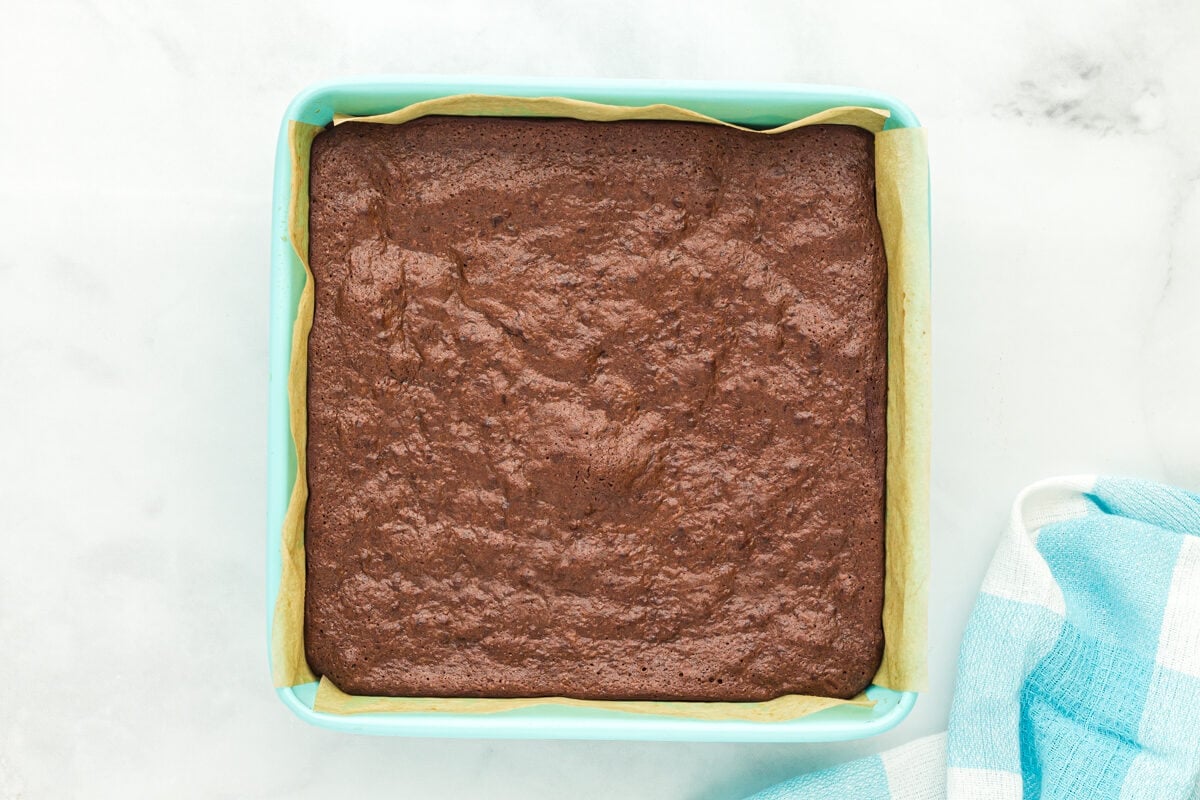 Baked flourless brownies in a brownie pan.