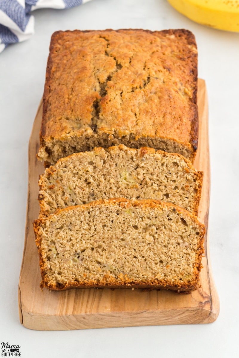 Oat Flour Banana Bread Recipe sliced on wooden board.