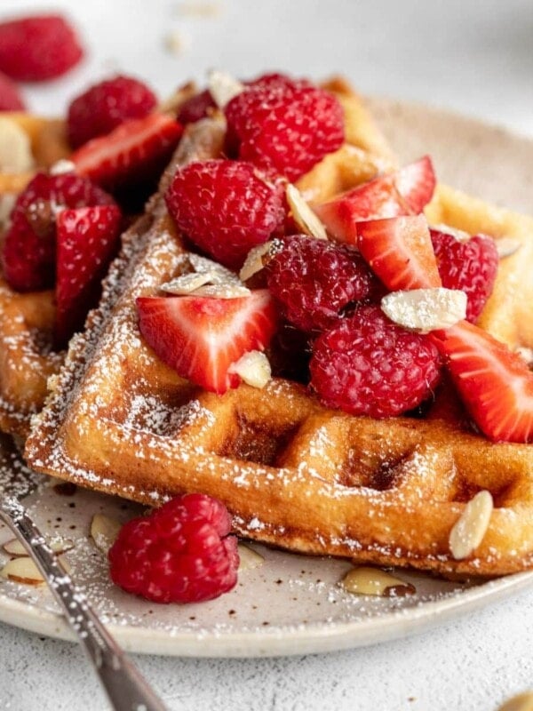 Almond flour pancakes with strawberries and almond flakes on top.