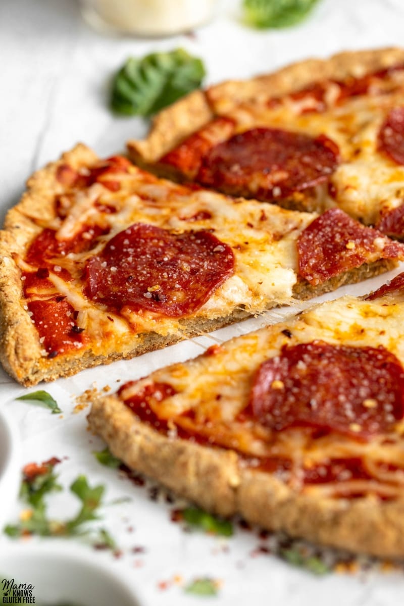 Close up of slice of pizza made using a Gluten-Free Almond Flour Pizza Crust.