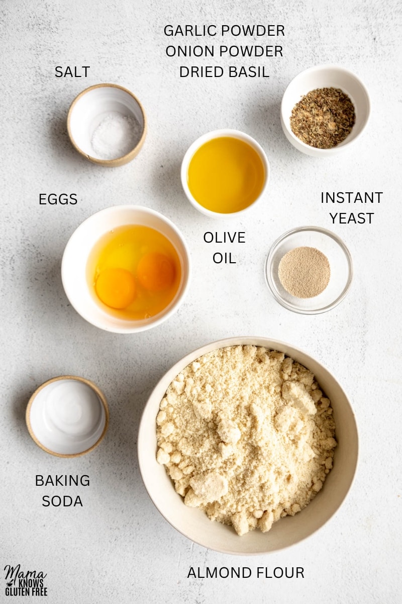 Ingredients for Gluten-Free Almond Flour Pizza Crust in bowls, cups and measuring spoons.