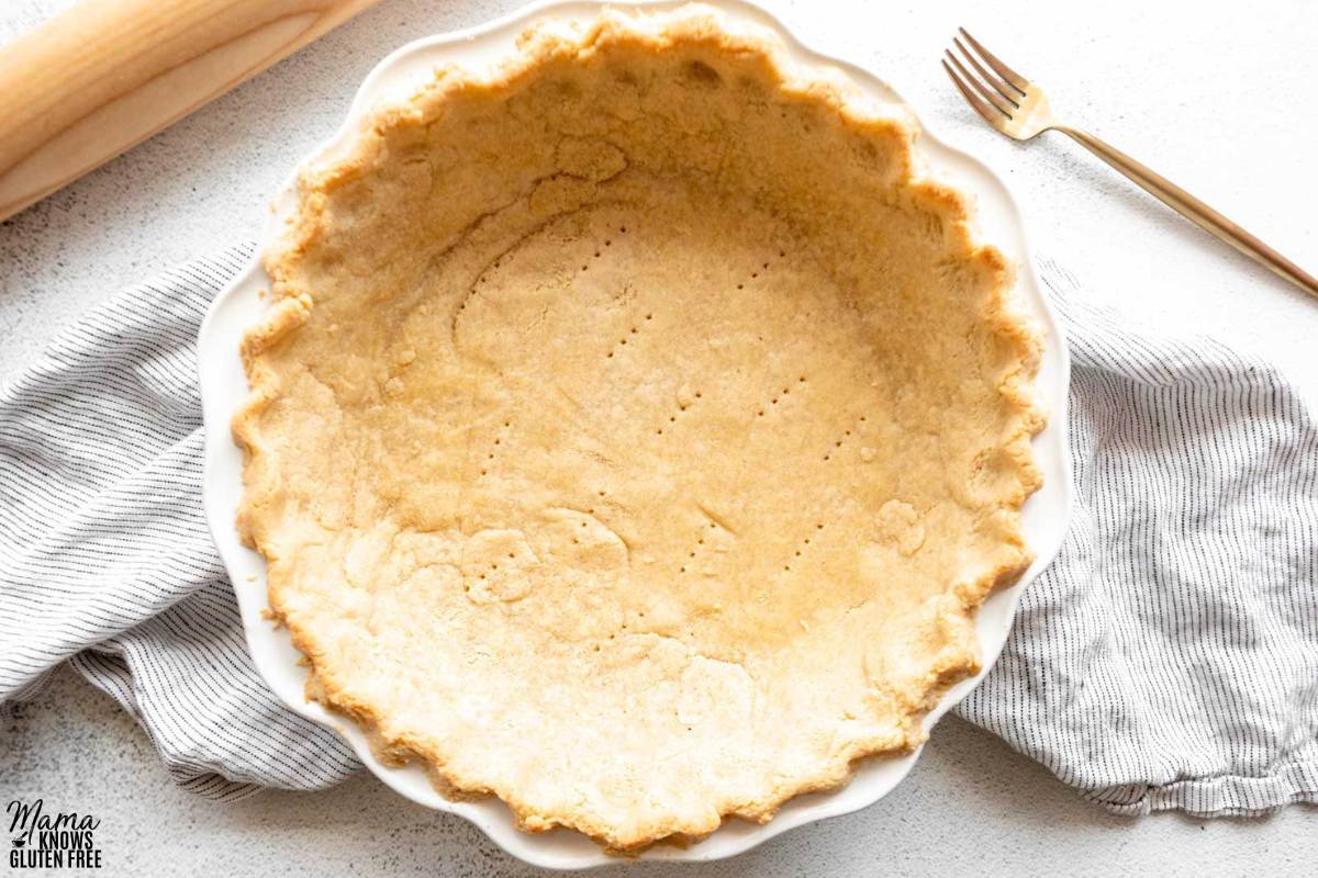 Gluten-Free Almond Flour Pie Crust baked in white pie plate.