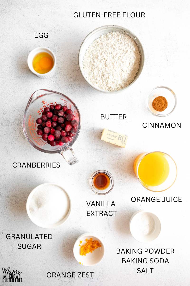 Ingredients for Gluten-Free Cranberry Bread measured out in bowls and cup.s