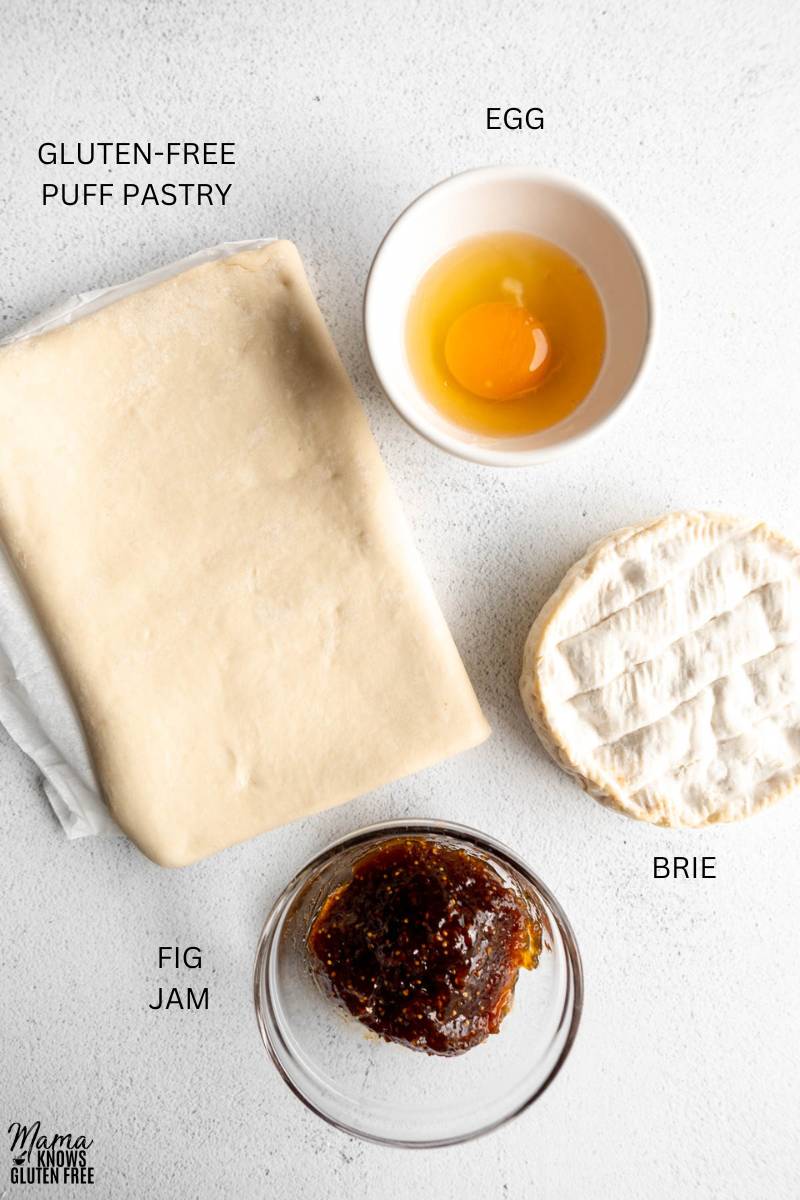 Ingredients to make Gluten-Free Baked Brie on white surface.