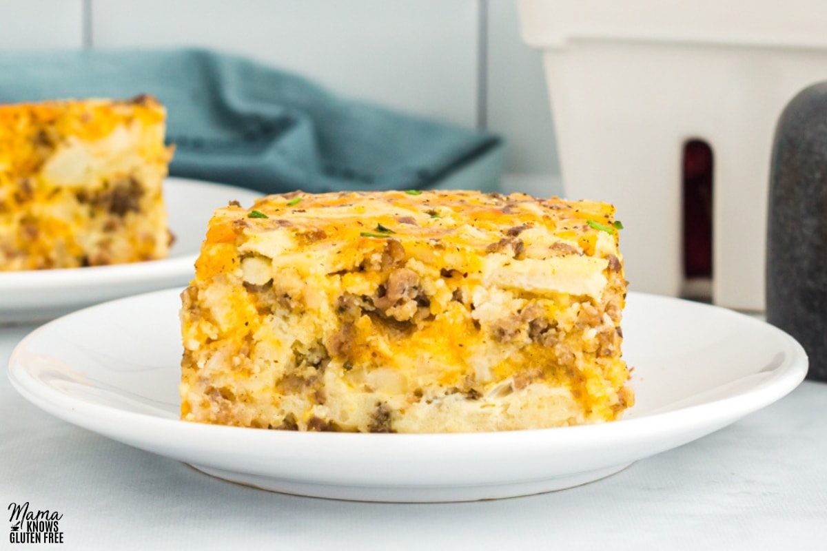 easy gluten-free breakfast casserole slice on a white plate with the casserole in the background