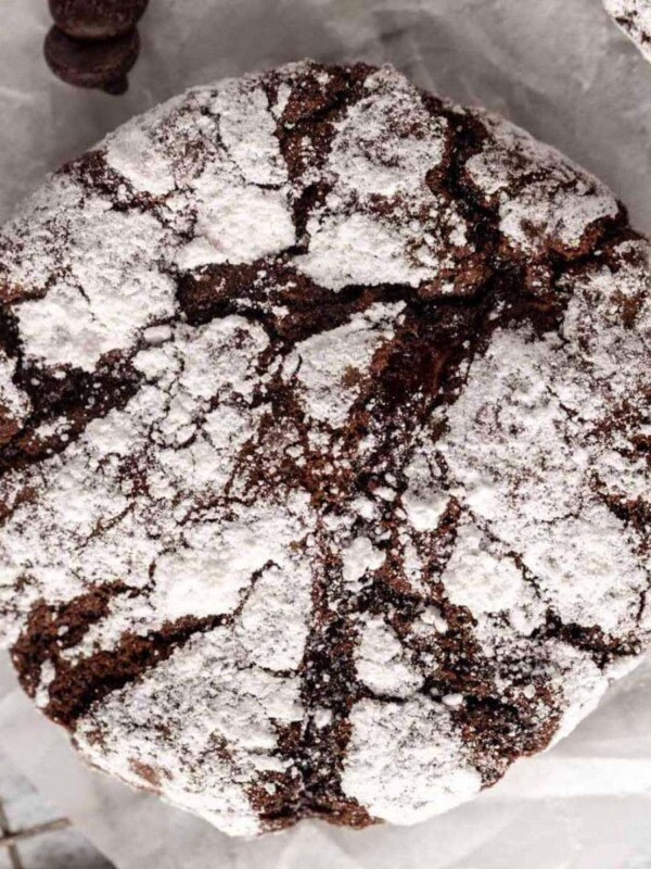gluten-free chocolate crinkle cookies on white parchment paper