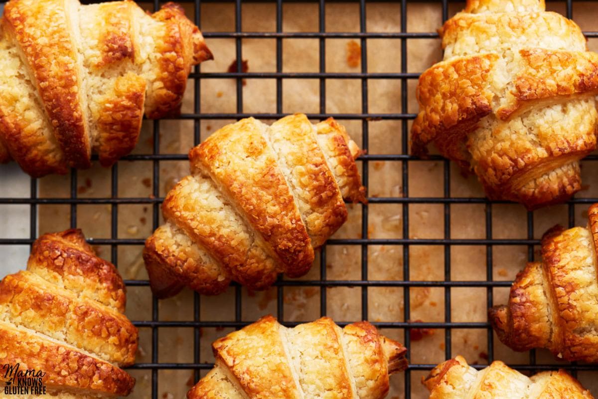 gluten-free croissants on a black cooling rack