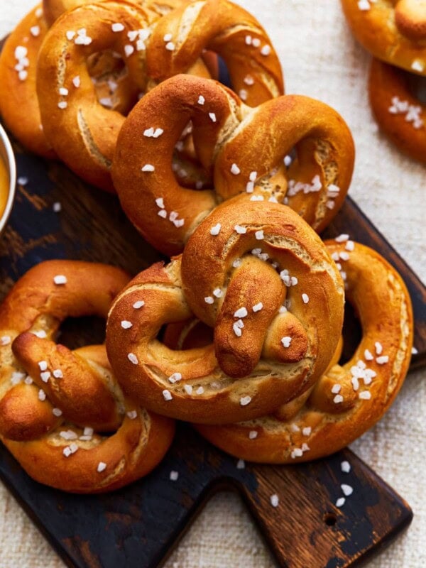 gluten free soft pretzels on a wooden cutting board.