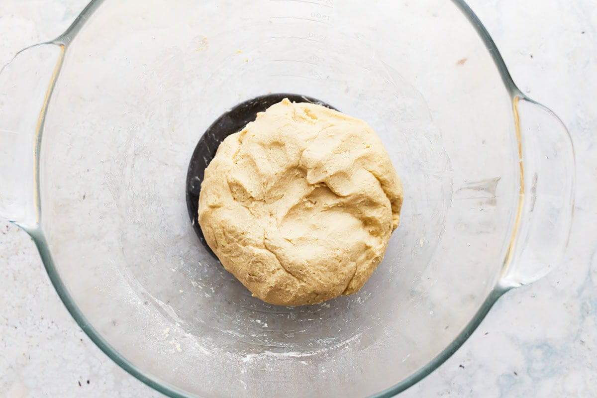 gluten free soft pretzel dough in a glass bowl.